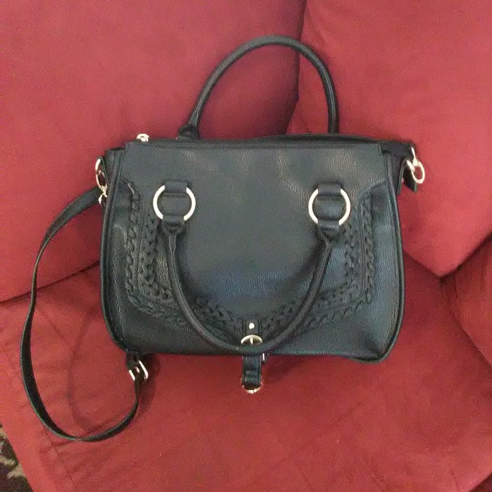 Black and gold leather bag with design on front